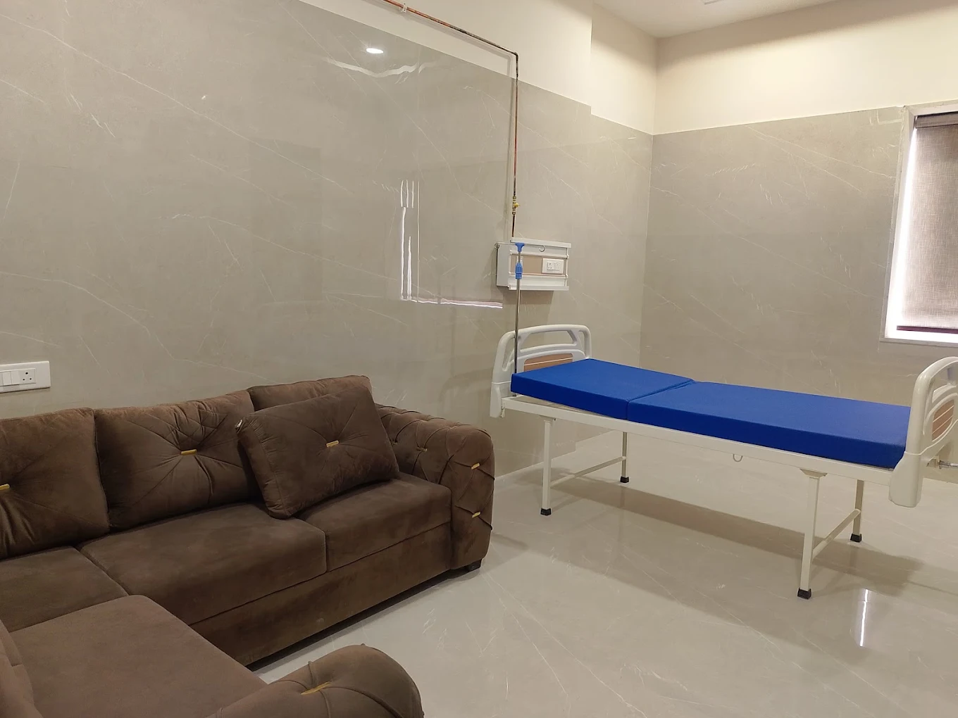 Patient room with bed and seating at Phoenix Hospital